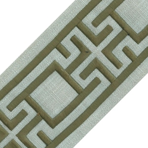 May include: Decorative trim featuring a geometric pattern in olive green embroidery on a light gray fabric. The trim has a textured appearance and a repeating design, suitable for various craft and home decor projects.