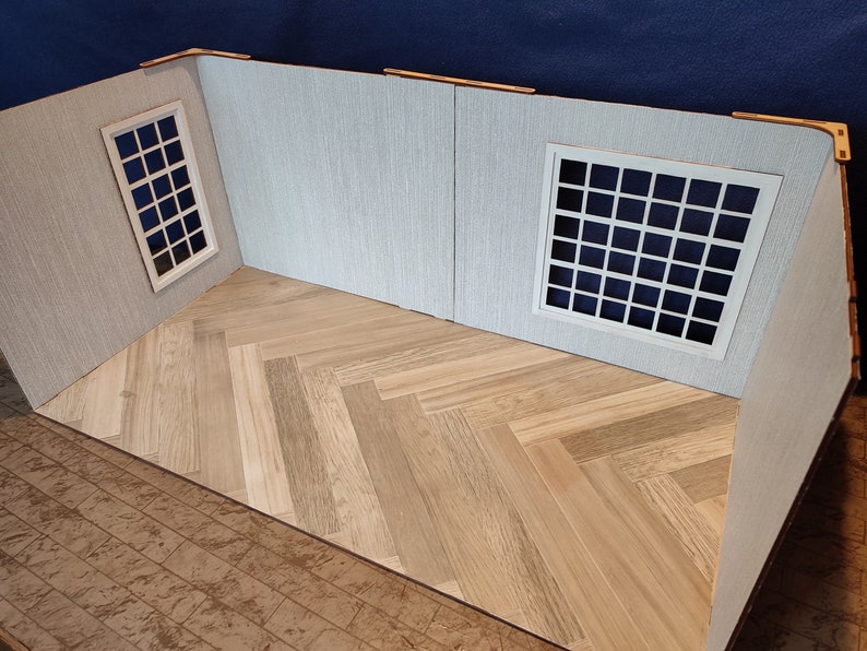 May include: A model room with white walls and a herringbone wood floor. There are two windows with white frames and a grid pattern.