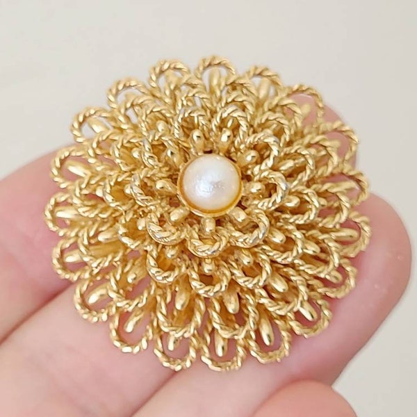 Signed Marcel Boucher flower brooch with a pearl center, 1955-1971.