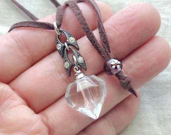 Facated puffy clear glass heart bottle pendant necklace, vintage rhinstone compotents, brown suede with glass bead adjustable closure.