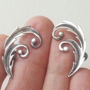 Vintage sterling silver feather swirl clip-on earrings, marked BK Sterling, curvy feather earrings.