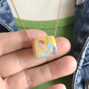 multicolor polymer clay bead with a very large holen on bronze chain necklace