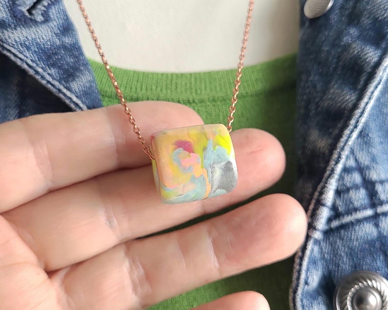 multicolor polymer clay bead with a very large holen on bronze chain necklace