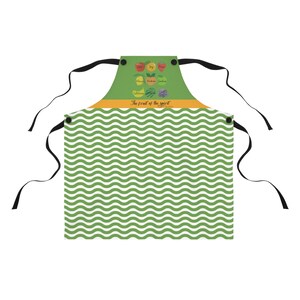 May include: Green and white wave patterned apron with black straps and a yellow and green panel featuring the text "The fruit of the spirit" and a graphic of fruit.