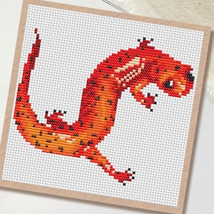 May include: A set of three ceramic mugs with a speckled, matte finish. The mugs are in shades of cream, light grey, and dark grey. Each mug has a simple, minimalist design, ideal for coffee or tea.