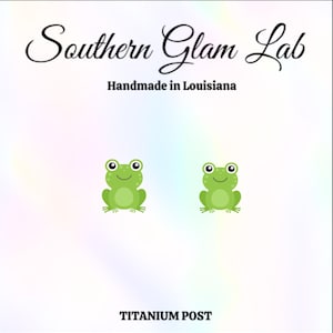 May include: A pair of green frog earrings with a titanium post. The earrings are handmade in Louisiana.