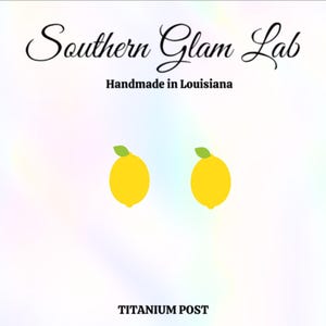 May include: A pair of lemon earrings with green leaves. The earrings are made with a titanium post. The earrings are handmade in Louisiana.