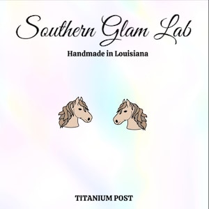 May include: A pair of gold horse head stud earrings with titanium posts. The earrings are handmade in Louisiana.