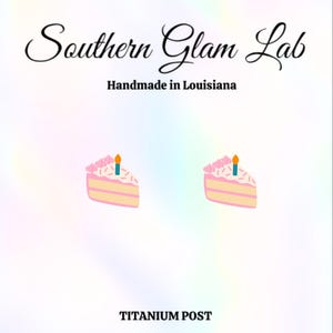 May include: A pair of pink and yellow birthday cake slice earrings with a single blue candle on top. The earrings are made with a titanium post.