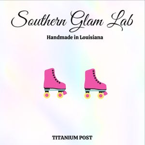 May include: A pair of pink roller skate earrings with black wheels and yellow accents. The earrings are made with a titanium post. The text "Southern Glam Lab" and "Handmade in Louisiana" is visible above the earrings.