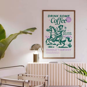 Cowgirl-inspired wall art print that says “Drink Some Coffee, Put Your Boots On, Handle Your Sh*t,” styled for a modern coffee bar or kitchen coffee station with a warm western vibe and motivational decor.