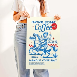 Cowgirl-inspired wall art print that says “Drink Some Coffee, Put Your Boots On, Handle Your Sh*t,” styled for a modern coffee bar or kitchen coffee station with a warm western vibe and motivational decor.