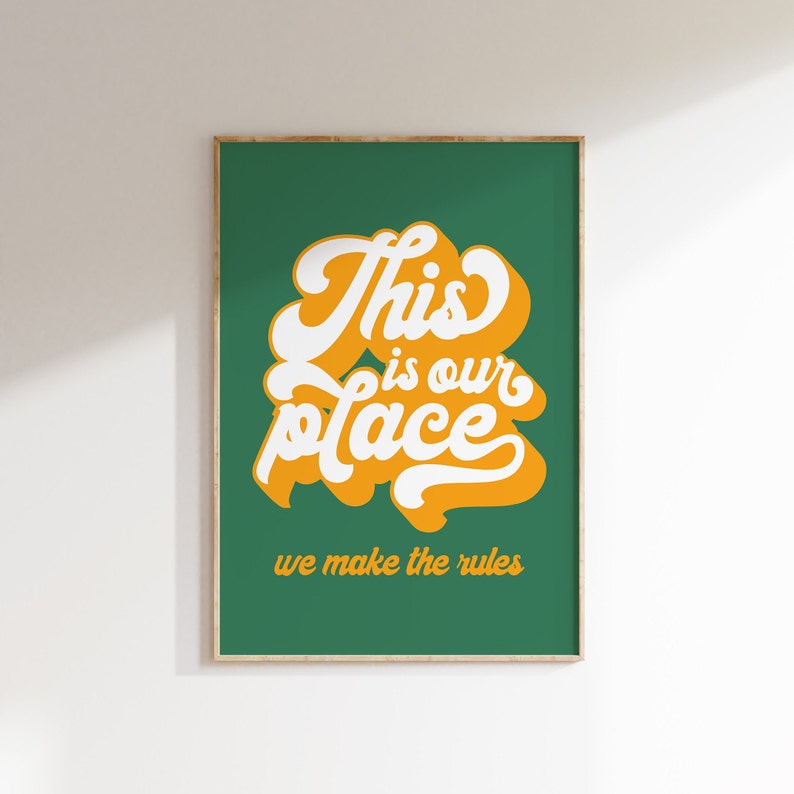 May include: A green poster with white text that reads "This is our place we make the rules" in a retro font. The text is outlined in yellow.