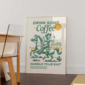 Cowgirl-inspired wall art print that says “Drink Some Coffee, Put Your Boots On, Handle Your Sh*t,” styled for a modern coffee bar or kitchen coffee station with a warm western vibe and motivational decor.
