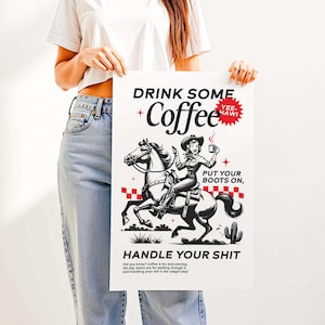 Cowgirl-inspired wall art print that says “Drink Some Coffee, Put Your Boots On, Handle Your Sh*t,” styled for a modern coffee bar or kitchen coffee station with a warm western vibe and motivational decor.