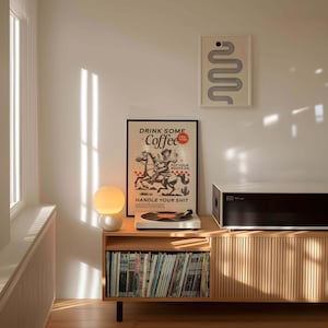Cowgirl-inspired wall art print that says “Drink Some Coffee, Put Your Boots On, Handle Your Sh*t,” styled for a modern coffee bar or kitchen coffee station with a warm western vibe and motivational decor.