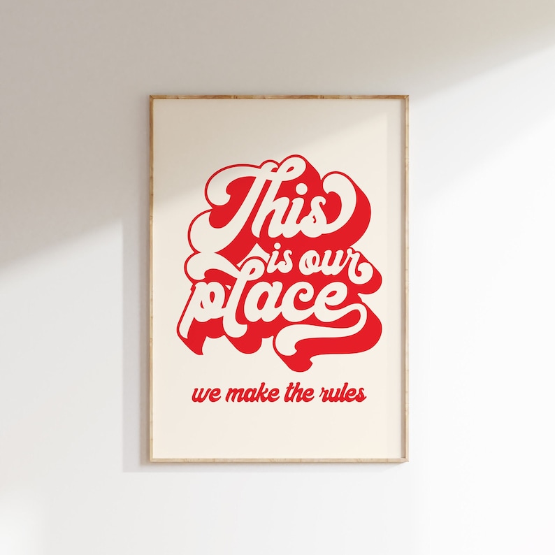 May include: A framed print with a red and white design that says "This is our place we make the rules".