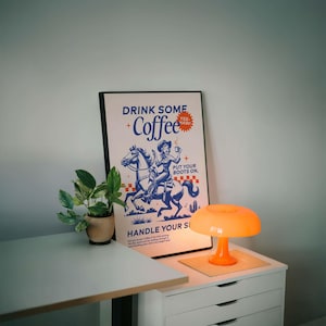 Cowgirl-inspired wall art print that says “Drink Some Coffee, Put Your Boots On, Handle Your Sh*t,” styled for a modern coffee bar or kitchen coffee station with a warm western vibe and motivational decor.