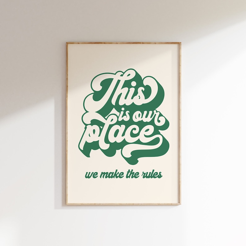 May include: A framed print with a green and white design that says "This is our place we make the rules".