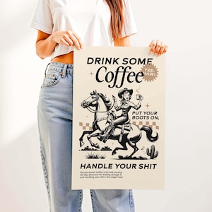 Cowgirl-inspired wall art print that says “Drink Some Coffee, Put Your Boots On, Handle Your Sh*t,” styled for a modern coffee bar or kitchen coffee station with a warm western vibe and motivational decor.