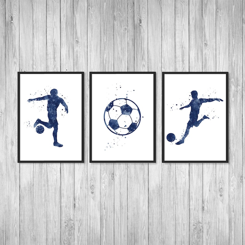 May include: Three framed prints with a blue watercolor design of a soccer player and a soccer ball. The prints are on a white background with black frames.