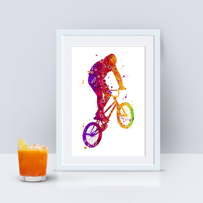 May include: A watercolor painting of a person riding a BMX bike. The person is silhouetted in shades of pink, orange, and yellow. The bike is also silhouetted in the same colors.