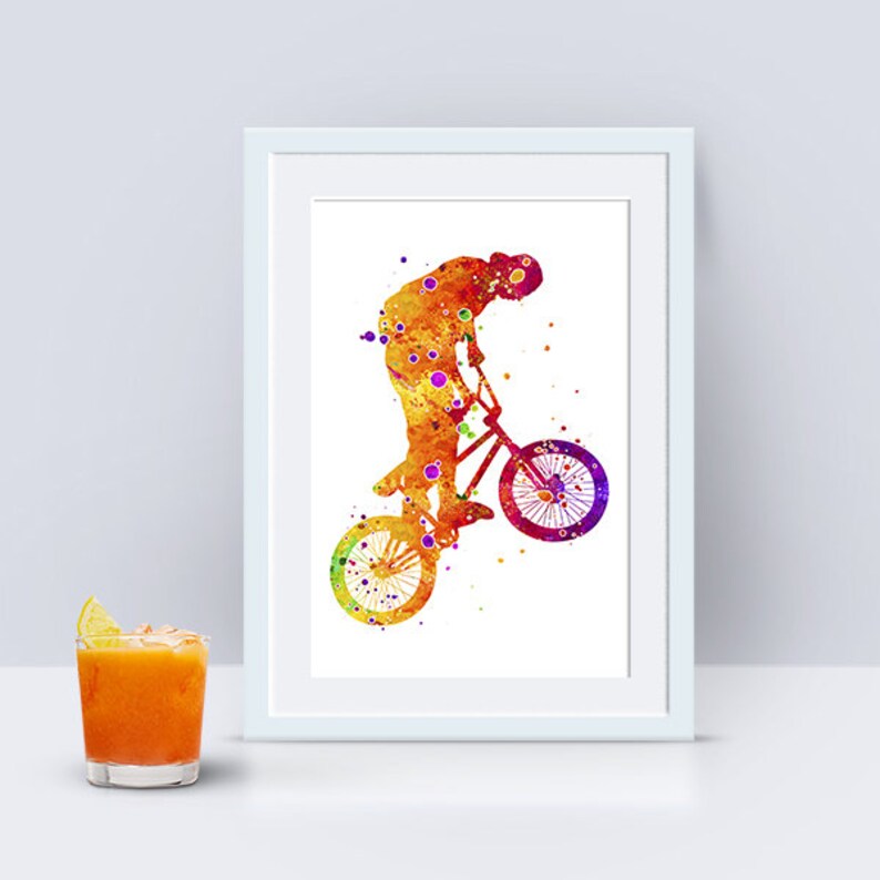 May include: A watercolor painting of a person riding a BMX bike. The person is in mid-air, with the bike's front wheel off the ground. The painting is done in shades of orange, yellow, and purple.