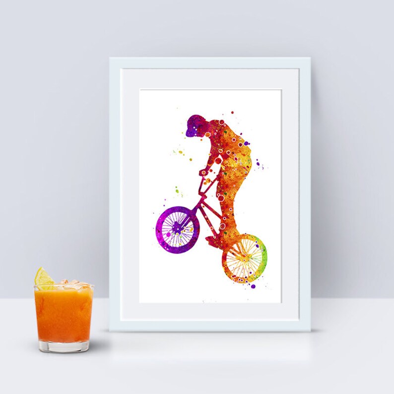May include: A watercolor painting of a person riding a BMX bike. The person is silhouetted in shades of orange, yellow, and red, with splashes of purple and blue. The bike is also silhouetted in shades of orange, yellow, and red, with splashes of purple and blue.