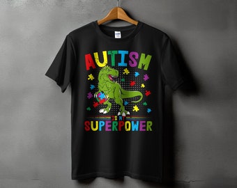 T-shirt de sensibilisation à l'autisme avec dinosaure, t-shirt drôle de soutien à la neurodiversité, pièces de puzzle arc-en-ciel