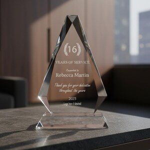 May include: A clear, diamond-shaped glass award trophy featuring an etched laurel wreath with the number 16, the text Years of Service, Presented to Rebecca Martin, Thank you for your dedication throughout the years, 2025, and Logo here if desired.