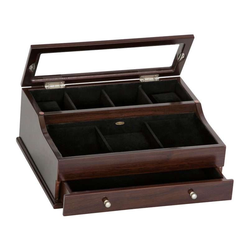 May include: A dark brown wooden jewelry box with a glass top and a drawer. The interior is lined with black fabric and features multiple compartments for organizing jewelry and accessories. The box has silver-colored knobs.