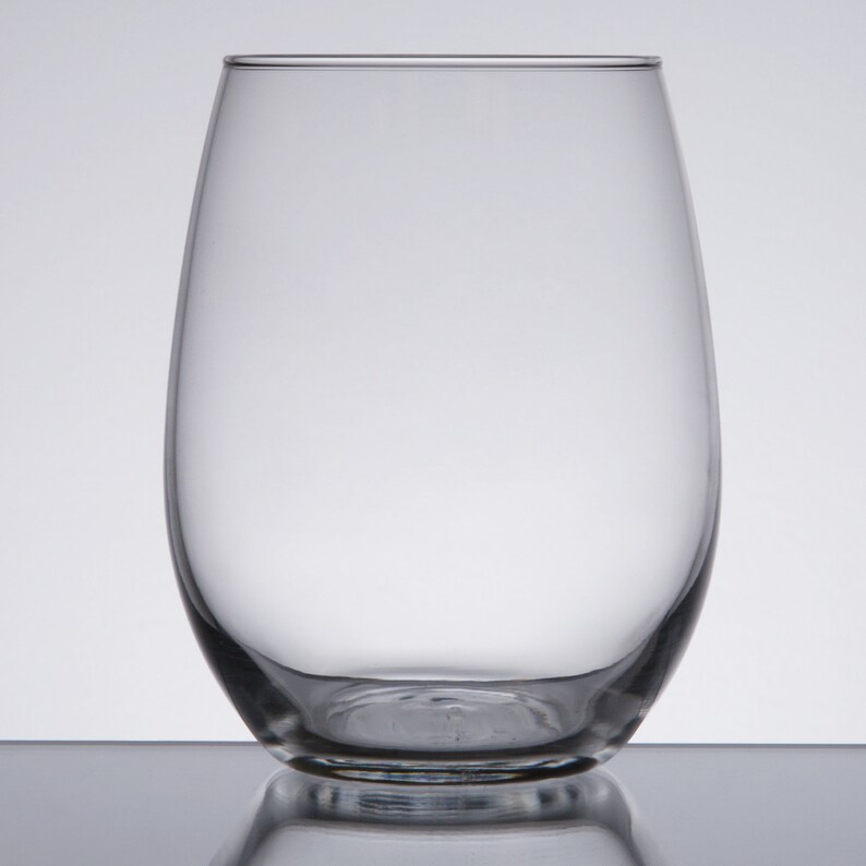 May include: A clear glass wine glass with a rounded base and a wide, open mouth.