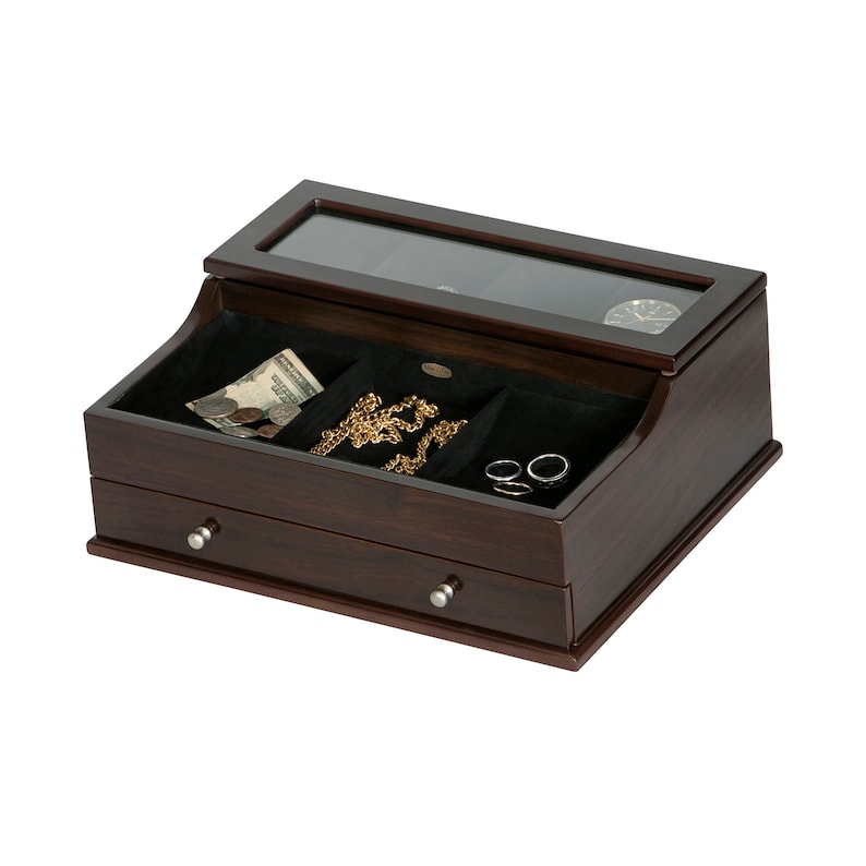 May include: A dark brown wooden jewelry box with a glass top and two drawers. The top compartment contains a watch display and three velvet-lined sections holding jewelry and money. Silver drawer pulls.