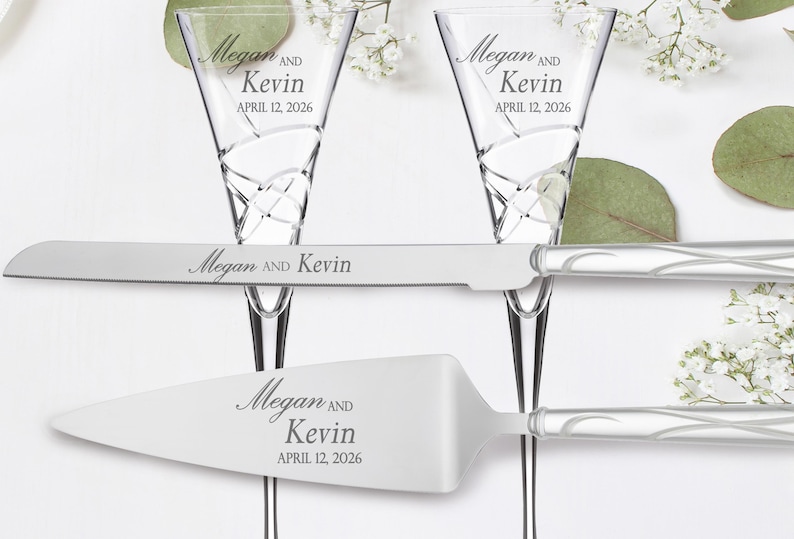 May include: A silver cake knife and server set with a swirl design on the handles. The knife and server are engraved with the names "Megan and Kevin" and the date "April 12, 2026".