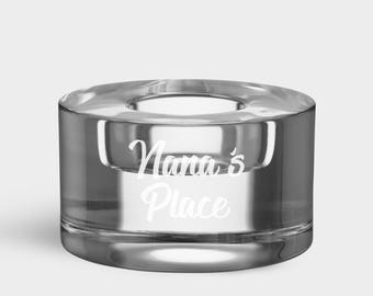 May include: A clear glass candle holder with the words "Nana's Place" etched on the side.