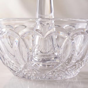 May include: A clear glass bowl featuring a central pillar and an intricate cut-glass pattern of interlocking heart shapes. The glass is engraved with the letters B&R and the date 9.17.26, showcasing a reflective surface and detailed geometric facets.