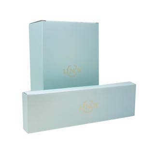 May include: Two light blue gift boxes with the word "LENOX" in gold lettering on each box.