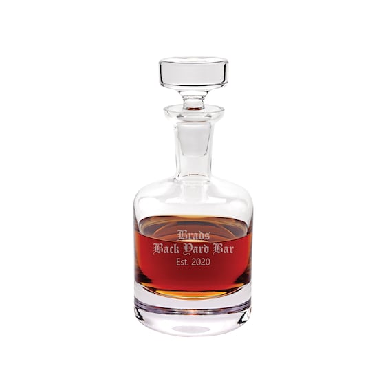 A 28oz modern crystal whiskey decanter with custom engraving — Badash is a real crystal brand and this is a genuinely elegant, displayable bar piece that earns its $125 price tag.