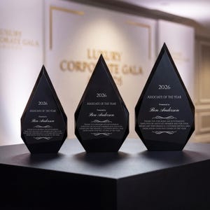 May include: Three black, diamond-shaped glass awards of varying heights, each engraved with the text 2026, Associate of the Year, Presented to Ben Anderson, and a message thanking the recipient for being an outstanding employee or associate.