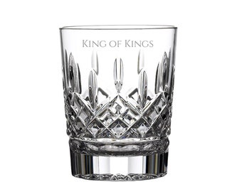 May include: A clear glass tumbler featuring a complex diamond-cut pattern on the lower half and a smooth upper rim. The text "KING OF KINGS" is etched in a serif font near the top of the glass. The base is thick and features vertical facets.