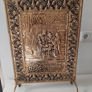 Antique brass fire screen depicting a tavern scene
