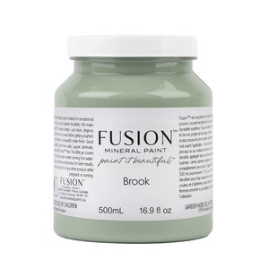 May include: A 500ml bottle of Fusion Mineral Paint in the colour Brook. The bottle is green and has a white label with the Fusion logo and the words "paint it beautiful".