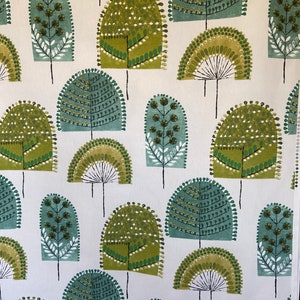 May include: A fabric textile featuring a repeating pattern of stylized trees in shades of olive green, sage green, and dark teal on a white background. The trees have rounded, arched tops with dotted textures and thin black vertical trunks.