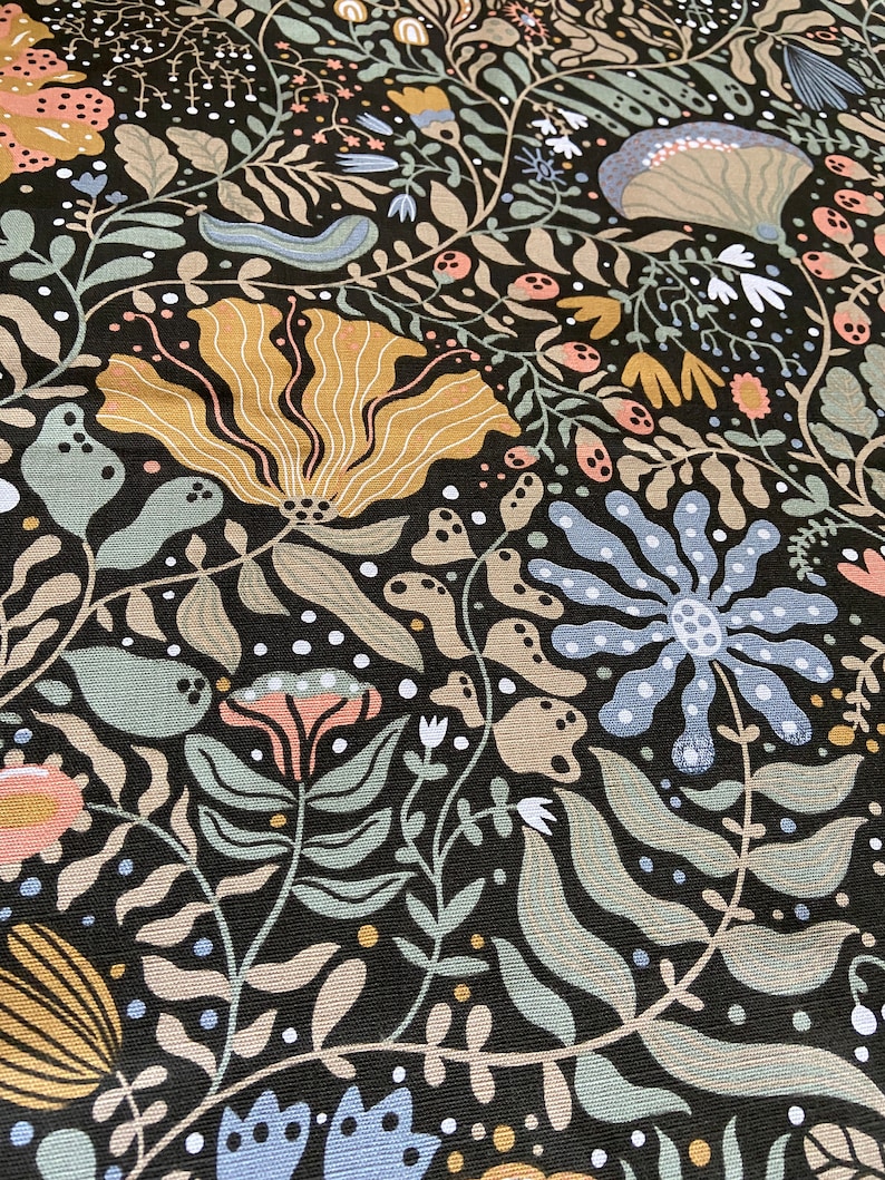 May include: A black fabric with a repeating pattern of stylized flowers and leaves in shades of blue, green, yellow, and pink.