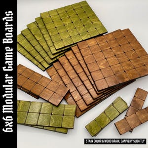 May include: A collection of square and rectangular wooden modular game boards featuring a grid pattern. The pieces are stained in olive green and medium brown tones, displaying natural wood grain. Text reads 6x6 Modular Game Boards and STAIN COLOR & WOOD GRAIN, CAN VARY SLIGHTLY.