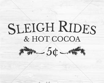 May include: A white wood-grain background featuring black text that reads SLEIGH RIDES & HOT COCOA. Below the text is the number 5 cents flanked by two black pine branch illustrations. At the bottom, the text reads LEMONADE DESIGN CO.
