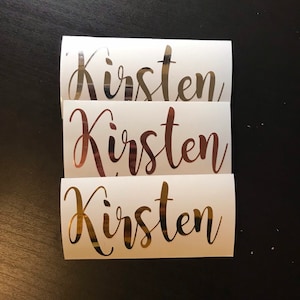 May include: Three gold foil stickers with the name "Kirsten" written in a cursive font.