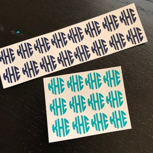 May include: Two sheets of monogram stickers. One sheet features navy blue KHE initials in an oval design, while the other has teal KHE initials. The stickers are on a white background.