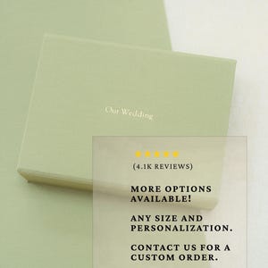 May include: A rectangular sage green gift box with the text Our Wedding printed in white on the lid. The box is presented with an overlay containing five yellow stars, the text 4.1K REVIEWS, MORE OPTIONS AVAILABLE, ANY SIZE AND PERSONALIZATION, and CONTACT US FOR A CUSTOM ORDER.