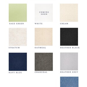 May include: A fabric color options chart displaying ten swatches labeled Sage Green, White with Coming Soon text, Cream, Stratum, Oatmeal, Heather Black, Navy Blue, Charcoal, Heather Grey, and French Blue, arranged in a grid on a white background.